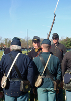 inpsecting the mens' muskets