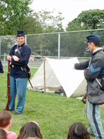 Sergeant Kent points to the canvas tent