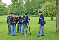 Bill oversees the stacking of arms